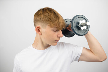 Teenage boy lifting a dumbbell