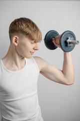 Teenage boy using a dumbbell