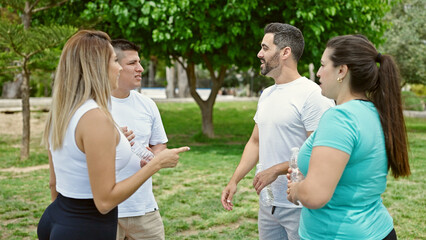 Group of people wearing sportswear speaking at park