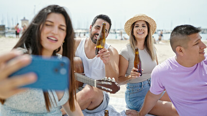 Group of people doing video call having party at beach