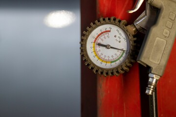 Closeup of a manometer in a car garage with a blurry background