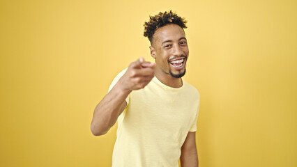 African american man smiling confident pointing with fingers to the camera over isolated yellow background