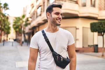 Young hispanic man smiling confident standing at street