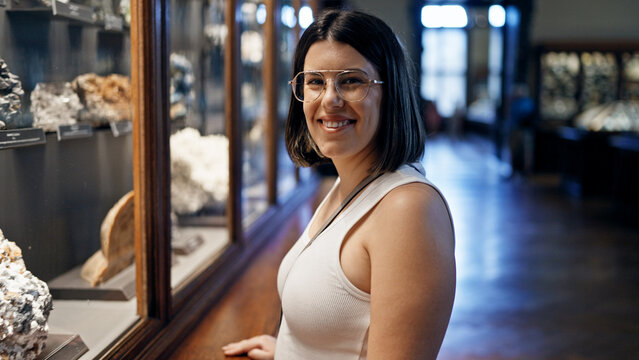 Young beautiful hispanic woman visiting geological exhibition at Natural History Museum in Vienna