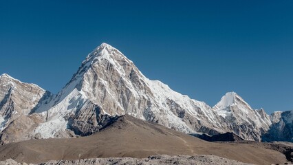 Snow-covered mountain slope in rocky and deserted landscape