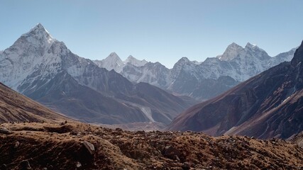 Majestic snowy mountain range with several prominent peaks in the background