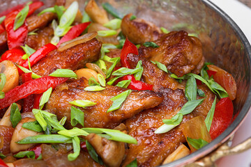 Fried meat with vegetables, green onions and mushrooms