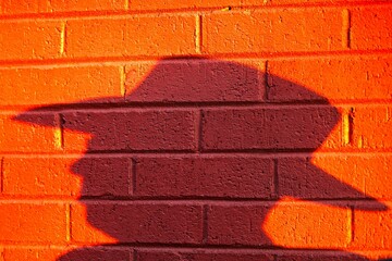 Silhouette of a cowboy in Nashville, TN against a vibrant orange backdrop