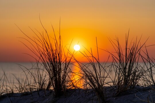 Stunning image of the sun setting over the Baltic Sea in Ahrenshoop, Germany