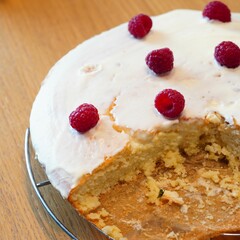 Delicious cut coconut cake, decorated with fresh raspberries