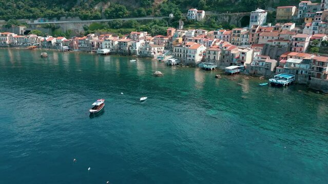 aerial view of the beautiful village of Scilla and Chianalea in Calabria. Note the houses overlooking the sea, the Ruffo castle, the seaside restaurants and the crystal clear Caribbean sea