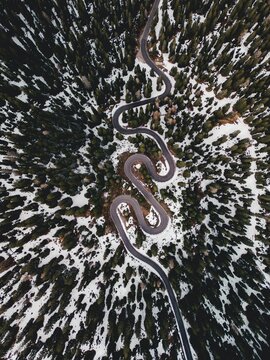 Aerial view of the winding Snake Road in winter in the Dolomite Alps of Italy.