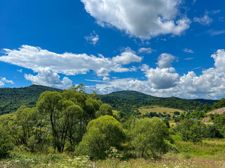 Obraz premium Awesome Carpathian mountains landscape background with forest and clouds on the summer season 