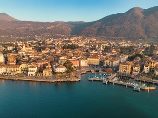 Fototapeta na wymiar Aerial view of the beautiful Iseo harbor with the city in the background in Italy