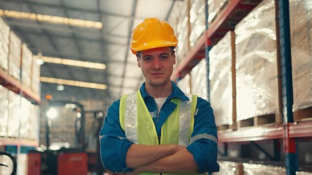 Happy professional worker looking at camera and smiling in the background warehouse with shelves full of delivery goods. Logistics, Delivery, and Distribution center.