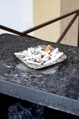 Outdoor ashtray in the smoking area closeup