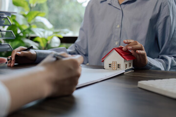 Real Estate Agent explain Property insurance and security concept about house to client before sign...