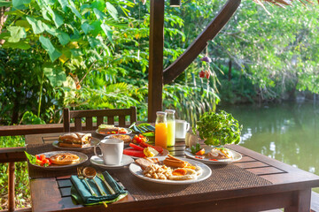 Restaurant near a beautiful lake in Asia. Enjoy a tasty and nutritious breakfast spread with a...
