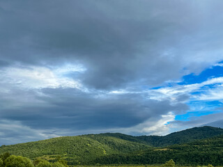 Fototapeta na wymiar Awesome Carpathian mountains landscape background with forest and clouds on the summer season