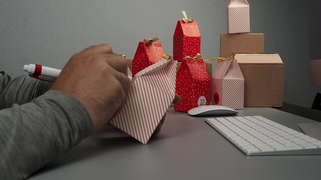 The packer in the warehouse sends a gift to the buyer through the online store. E-commerce, delivery of goods, color boxes for gifts.