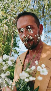 portrait of a person with a flower,man holding plants and flowers, portrait of a man, portrait, flowers, man with flowers, portraits of a man with plants and flowers, face, naked, handsome, body, pers
