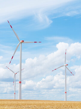 Wind turbine in front of bright blue sky