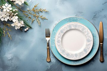 Blue and white table setting with Christmas dinnerware and decorations.
