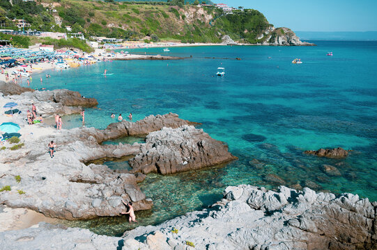 Italy, July 2023: view of the spectacular and relaxing Grotticelle beach near Capo Vaticano in Calabria. You notice the rocks and the bathers having fun during their vacation
