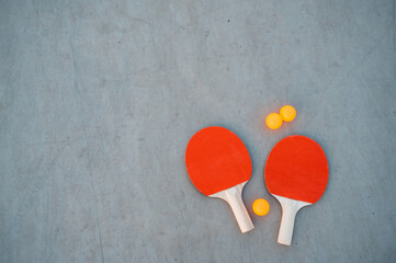 Ping pong paddle and balls on grey background. Table tennis inventory. Close up . Mock-up, copy space, banner. 