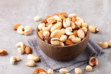Healthy mix nuts on wooden background. Almonds, hazelnuts, cashews, peanuts, pistachios, Brazilian nuts