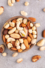 Healthy mix nuts on wooden background. Almonds, hazelnuts, cashews, peanuts, pistachios, Brazilian nuts