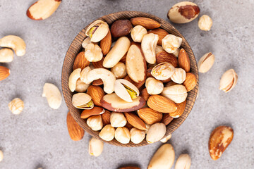 Healthy mix nuts on wooden background. Almonds, hazelnuts, cashews, peanuts, pistachios, Brazilian nuts