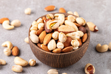 Healthy mix nuts on wooden background. Almonds, hazelnuts, cashews, peanuts, pistachios, Brazilian nuts