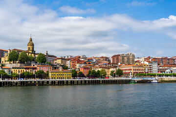 Naklejka na ściany i meble Portugalete town by Nervion river, and Sandra Maria basilica, Basque Country, Spain.