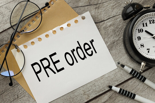 a table clock. wooden background page with text Pre-Order