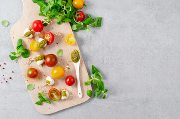 Fototapeta na wymiar Italian Caprese Canapes Salad With Tomatoes, Mozzarella And Fresh Basil, Tasty Snack