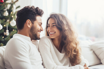Obraz premium Closeup photo of adorable couple spending holly Christmas eve in decorated garland lights room near Chrismas tree sitting cosy sofa indoors