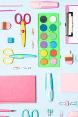 Seamless pattern with bright stationery supplies on light blue background top view. Back to school concept.