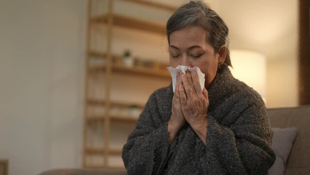 Sick senior women feeling unwell coughing, flu, common cold, fever, infection