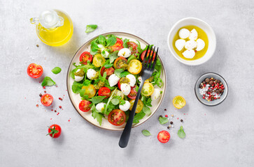 Caprese Salad with Cherry Tomatoes and Pesto Sauce over Bright Background