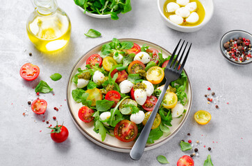 Caprese Salad with Cherry Tomatoes and Pesto Sauce over Bright Background