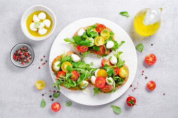 Bruschetta with Cherry Tomatoes, Mini Mozzarella Cheese and Pesto Sauce, Caprese Toasts