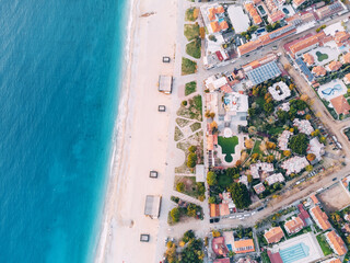 Aerial rooftop cityscape view of a resort old town and blue sea with white sand beach