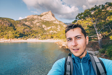 Happy man taking selfie admiring view of a scenic sea coast. Lycian Way travel sights