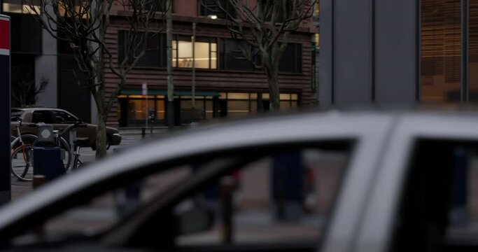 Row of Green bicycles for rent. Electric bicycle charging station. Shared electric bikes parked on city street early in the morning