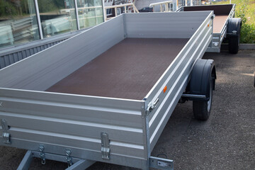 Obraz premium Open car trailer.Sale and rental of trailers for cargo transportation