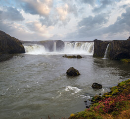 Picturesque full of water big waterfall Godafoss autumn dull day view, north Iceland.