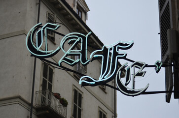 Blue neon cafe sign in Milan, Italy