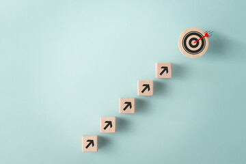 Business growth, objective goal achievement concept. Wooden block with target aiming dart board and...