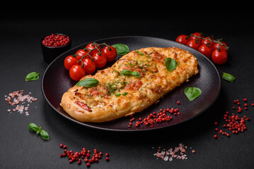 Delicious oven fresh flatbread pizza with cheese, tomatoes, sausage, salt and spices